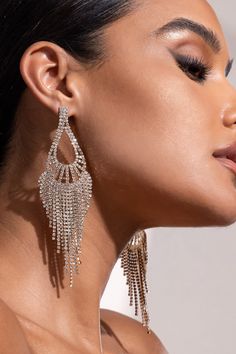 Time for some glow! Our gorgeous earrings are a must-have for evening occasions. Designed in a glamorous golden shade, these earrings feature a diamante teardrop with a delicate tassel for a sophisticated look. Wear these earrings to your next black-tie event, after-party or gala. Priceless is an understatement for this pair! Glamorous Gold Tassel Earrings For Wedding, Glamorous Dangle Tassel Earrings For Pierced Ears, Glamorous Dangle Tassel Earrings, Gold Crystal Tassel Earrings For Evening, Gold Rhinestone Tassel Dangle Earrings, Gold Tassel Dangle Earrings With Rhinestones, Crystal Teardrop Earrings For Party, Glamorous Tassel Earrings For Party, Glamorous Tassel Drop Earrings