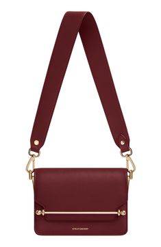 A wide shoulder strap updates this sought-after style crafted in Spain from burgundy-colored calfskin and secured with a signature bar closure. A chain crossbody strap offers another elegant way to carry this compact bag. Slip-flap closure Removable shoulder strap; removable chain crossbody strap Interior wall pocket Textile lining Leather Made in Spain Designer Handbags Formal Burgundy Shoulder Bag With Adjustable Strap, Burgundy Evening Crossbody Flap Bag, Elegant Red Saddle Bag With Gold-tone Hardware, Burgundy Flap Shoulder Bag With Detachable Strap, Evening Bag With Detachable Strap, Burgundy Shoulder Flap Bag With Detachable Strap, Luxury Burgundy Shoulder Bag With Adjustable Strap, Burgundy Crossbody Flap Bag For Formal Occasions, Chic Burgundy Leather Flap Bag