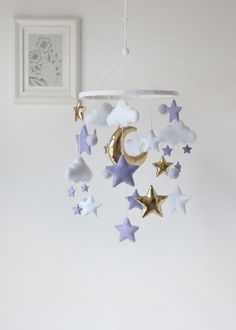 a baby crib mobile with stars hanging from it