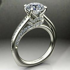 a white gold engagement ring with an oval cut diamond and side stones on the band