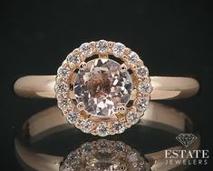 an engagement ring with a fancy center stone surrounded by round brilliant cut diamonds on a black background