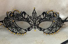 Black Lace Masquerade Mask with Gold Glass Diamantes Black Double 6mm Satin Ribbons each side (Approx 1m) to secure your Mask or Gold Double 6mm Satin Ribbons (Please let me know when ordering your Mask what colour Ribbons you would prefer)  Comfortable to wear all Evening Complete with Silver Organza Carry Bag Measures: 8.5" by 3" Approx and will fit most Adults Beautiful Mask for any Special Occasion Masquerade Balls New Year's Eve Party Christmas Party Proms Weddings Halloween Parties https:/ Black Masquerade Mask For Halloween Wedding, Black Adjustable Masquerade Mask For Party, Adjustable Black Masquerade Mask For Parties, Adjustable Masquerade Mask For Carnival Party, Gold Gothic Masquerade Mask For Party, Gold Masks For Halloween Party, Fitted Black Masquerade Mask For Halloween, Fitted Black Eye Mask For Masquerade, Adjustable Mardi Gras Party Mask