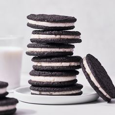 a stack of cookies sitting next to a glass of milk