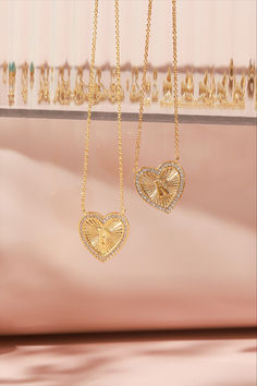 Two gold vintage-inspired heart initial necklaces with an intricate textured pattern and surrounded by small crystals. One heart displays the initial 'P' and the other 'K,' both suspended on a gold chain against a soft pink backdrop. Heart Pendant Monogram Jewelry For Anniversary, Tarnish Resistant Initial Pendant Charm Necklace For Valentine's Day, Valentine's Day Tarnish Resistant Initial Pendant Charm Necklace, Valentine's Day Initial Pendant Necklace Tarnish Resistant, Valentine's Day Tarnish-resistant Initial Pendant Charm Necklace, Vintage Necklaces For Valentine's Day Personalized Gift, Monogram Initial Pendant Jewelry For Valentine's Day, Heart Shaped Monogram Jewelry For Anniversary, Gold Open Heart Necklace With Initials