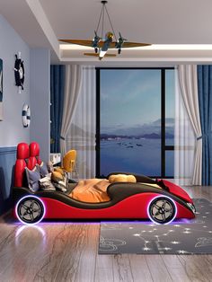 a bedroom with a red car bed in the middle