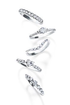 three rings with diamonds on each side and one in the middle, set against a white background