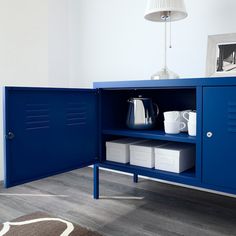 a blue cabinet with some white containers in it