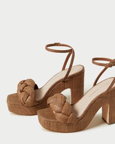 Platform sandal in brown raffia with puffy braided detail. Features a padded footbed with gold stamped logo. Open toe with adjustable buckle ankle strap. 4.5-inch heel, 1-inch platform. The Fae, Bow Heels, Platform Sandals Heels, Braided Strap, Loeffler Randall, Platform Heel, Sport Sandals, 5 Inch Heels, Womens Wedges