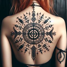 the back of a woman's body with tattoos on it