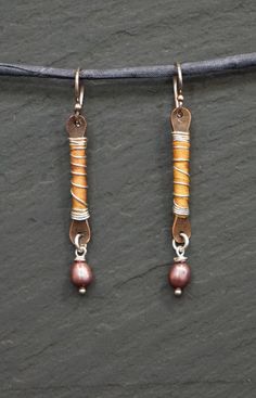 Golden Petals- These earrings are of hand stamped copper, hand wrapped with hand dyed silk. The silk is hand wrapped in sterling silver wire.  Cranberry fresh water pearls wrapped with sterling silver accent  each earring. Ear wires and jump rings are also sterling silver. These earrings measure a total of 4.75 cm.  4 mm. in width max. 10% of this sale will go to buyer's valid charity. Please state valid charity choice at check out. Wear in peace, live in light. Kindness, Anna Artisan Nickel-free Rust-colored Jewelry, Artisan Rust Color Nickel-free Jewelry, Artisan Rust-colored Nickel-free Jewelry, Artisan Hand Wrapped Copper Earrings, Handmade Copper Wrap Earrings, Handmade Unique Copper Wrap Earrings, Unique Handmade Copper Wrap Earrings, Adjustable Silver Copper Wrap Earrings, Ear Wraps