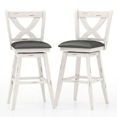 two white wooden barstools with black leather seat cushions against a white background,