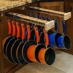 pots and pans are hanging from the rack in this kitchen counter top spacer