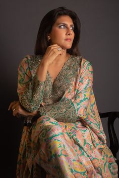 Rama green kaftan with all over vintage print, resham, zardozi applique embroidered V neck and sleeve cuffs. Paired with printed straight fit pant.
Components: 2
Pattern: Printed and Applique Embroidered
Type Of Work: Vintage Print, Resham and Zardozi Work
Neckline: V Neck
Sleeve Type: Batwing Sleeves
Fabric: Pure Silk
Color: Green
Other Details: 
Cut work hem details
Asymmetric hem on kaftan
Inner trim panel
Occasion: Mehendi and Haldi,Sangeet - Aza Fashions Festive Chanderi Kaftan With Printed Motifs, Anarkali Multicolor Kaftan With Dabka Work, Anarkali Long Sleeve Kaftan With Printed Motifs, Anarkali Style Long Sleeve Printed Kaftan, Multicolor Embroidered Kaftan With Zari Work For Festive Season, Green Jamawar Dress With Intricate Embroidery, Bollywood Style Multicolor Embroidered Kaftan For Eid, Festive Embroidered Kaftan With Zari Work, Festive Multicolor Embroidered Kaftan With Zari Work