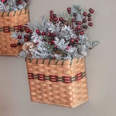 two baskets with christmas decorations hanging on the wall