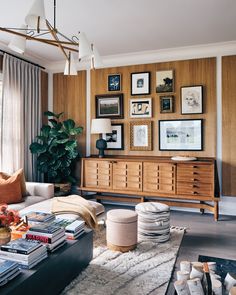 a living room filled with furniture and pictures on the wall