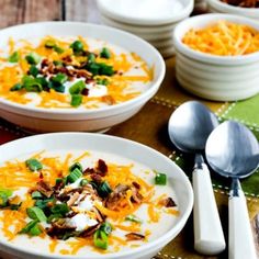 several bowls of food on a table with spoons