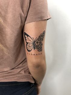 a woman's arm with a butterfly tattoo on the back of her left arm