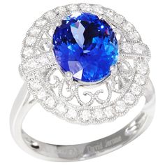 This ring designed by David Jerome is from his private collection and features one oval cut Tanzanite totalling 3.96cts sourced from the D block Mine in Tanzania. Set with round brilliant cut Diamonds totalling 0.45cts mounted in an 18k white gold setting. UK finger size N, EU size 54, USA size 6 1/2. David prides himself in only sourcing the finest and most exclusive gemstones whose natural beauty and colour enhance the settings he creates for each piece. These exclusive designs offer buyers a unique opportunity to own the kind of jewellery usually reserved for the finest and most exclusive brands in the world. A real legacy for the future. British Art, Art Deco Diamond, Round Brilliant Cut Diamond, Cocktail Rings, Tanzania, Oval Cut, Round Brilliant, Exclusive Designs, Ring Designs