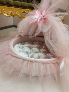 a cat bed with pink tulle and bows