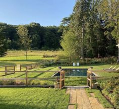 an outdoor pool surrounded by lush green grass