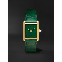 This classic timepiece was first introduced by Louis Cartier in 1917 and draws inspiration from the tanks that traversed the WW1 battlefields, the vertical lines on the dial, also known as 'brancards', are intended to represent the treads, while the case is modelled on the terret. It's animated by an intricate Swiss-made hand-wound movement and crafted from 18-karat gold with a single sapphire cabochon studding the crown. The green jewel tone is perfect for special occasions and will complement… Cartier Gold Watch, Tank Louis Cartier, Cartier Tank Louis, Cartier Gold, Hand Wound, Sapphire Cabochon, Latest Watches, Gold Watch Men, Cartier Tank