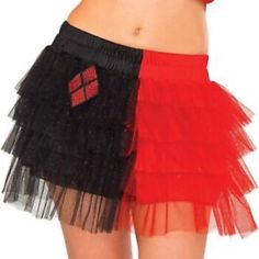 the woman is wearing a red top and black tulle skirt with an argyle patch on it