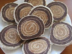 a white plate topped with cookies on top of a wooden table covered in frosting