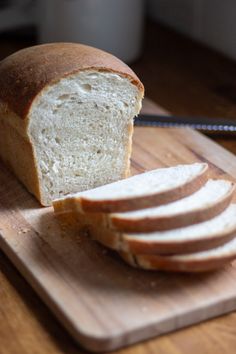 sliced loaf of bread sitting on top of a cutting board