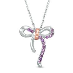 Decorate your party look with this feminine gemstone necklace. Crafted in sterling silver, this darling piece is centered with a sweet looping bow - lined partly with petite bright purple amethyst and finished with a polished 10K rose gold detail. Buffed to a brilliant luster, this 18.0-inch rope chain necklace secures with a spring-ring clasp. Gift Jewelry With Pink Bow, Pink Ribbon Jewelry As Gift, Pink Ribbon Jewelry Gift, Pink Ribbon Jewelry For Gifts, Rose Gold Jewelry With Bow For Gifts, Pink Bow Jewelry For Anniversary, Elegant Pink Bow Jewelry Gift, Elegant Pink Bow Jewelry For Gift, Sterling Silver Birthstone Necklaces For Parties