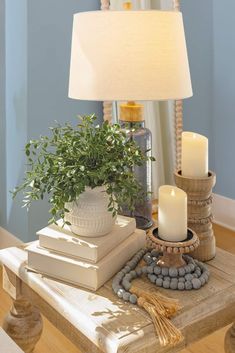 a table with some books and candles on it