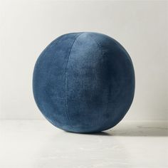 a blue ball sitting on top of a white table