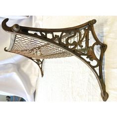 an old iron shelf with decorative designs on it