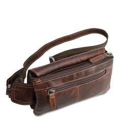 FREE GROUND SHIPPING & FREE MONOGRAMMING! HAND-STAINED BUFFALO LEATHER Travel around town with your hands-free and your must-have items kept safely inside this stylish belt bag. The Voyager Waist Bag is made from vegetable re-tanned buffalo leather and features a small profile and a rustic design with multiple storage pockets with a single adjustable strap that makes it comfortable to wear. This bag has a top zippered main compartment with a front magnetic flap-over pocket, back zippered poc Cross Shoulder Bag, Cross Shoulder Bags, Leather Waist Bag, Leather Fanny Pack, Leather Belt Bag, Buffalo Leather, Must Have Items, Pocket Top, Leather Travel