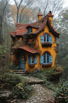 a yellow house with blue shutters on the windows and red tile roof, surrounded by greenery