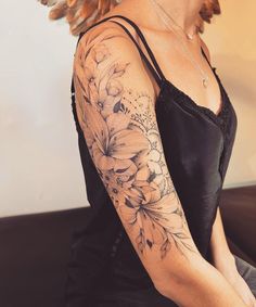 a woman with a flower tattoo on her arm