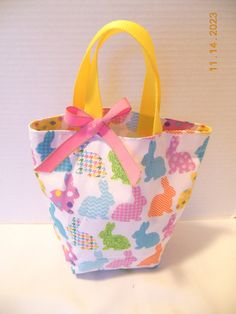 Looking for an Easter basket or gift bag, this little purse/tote will delight any little girl or toddler who likes to be just like Mommy! Perfect for taking along any essentials for a shopping trip, restaurant, off to Grandma's or the beach for the day. Plenty of room for crayons, "make up," a few little toys or whatever she might need - even a pair of pj's would fit. Can also be used as a gift bag or as a party favor. This little bag measures approx. 10 inches wide by 9 inches tall. Fully lined Cute Pink Lunch Bag For Gift, Fun Rectangular Bags For Gifts, Fun Rectangular Bags Ideal For Gifts, Fun Rectangular Gift Bags, Cute Multicolor Bags For Gift, Handmade Fun Bags For Gifts, Fun Rectangular Lunch Bag Gift, Fun Rectangular Lunch Bag For Gift, Cute Rectangular Lunch Bag For Playtime