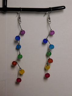 Cute and fun multicolored dangle earrings Frosted multicolored beads staggered on silver wire. Multicolor Wire Wrapped Drop Earrings, Multicolor Wire Wrapped Dangle Beaded Earrings, Multicolor Wire Wrapped Earrings With Round Beads, Rainbow Dangle Earrings With Ear Wire, Multicolor Wire-wrapped Beaded Earrings For Gift, Multicolor Czech Glass Dangle Earrings, Multicolor Wire Wrapped Beaded Earrings For Gift, Multicolor Czech Glass Drop Earrings, Multicolor Wire Wrapped Beaded Earrings As Gift