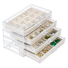 three clear drawers filled with jewelry on top of each other