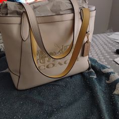 Brand New . Beige With Authentic Horse And Carriage On Front . Leather I Paid 550 In La Designer Beige Bag For On-the-go, Cream Coated Canvas Shoulder Bag With Removable Pouch, Cream Shoulder Bag With Removable Pouch In Coated Canvas, Gold Coated Canvas Bag With Double Handle, Coach Beige Shoulder Bag With Dust Bag, Beige Coach Shoulder Bag With Dust Bag, Gold Shoulder Bag With Leather Handles And Coated Canvas, Cream Rectangular Coated Canvas Shoulder Bag, Gold Coated Canvas Bag With Handles