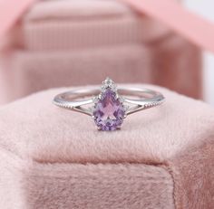 Pear Shaped Amethyst Ring, Teardrop Amethyst Ring, White Gold Purple Engagement Rings, February Birthstone Ring, Lavender Promise Ring ✧･ﾟ: *✧･ﾟ:* Welcome to Charles Davin Jewelry*:･ﾟ･ﾟ✧ Moissanite - a gemstone known to bring in luck in someone's life, the user can give off a look of elegance. You can give your special someone luck whilst showing your love to them. ✶Material: 10K/ 14K/ 18K ✶Main Stone: Natural Amethyst; 5*7mm ✶Side Stone: Moissanite; Total: 0.07ct ✶Color: D Colorless ✶Clarity: V Cheap Purple Promise Ring, Promise Rings For Her Purple, Luxury Lavender Promise Ring, Luxury Elegant Pear-shaped Amethyst Ring, Luxury Lavender Amethyst Promise Ring, Amethyst Ring Vintage Silver, Pear-shaped Purple Amethyst Ring With Prong Setting, Purple Pear-shaped Amethyst Ring With Prong Setting, Purple Pear-shaped Ring With Prong Setting