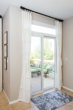 a living room with sliding glass doors leading to the patio