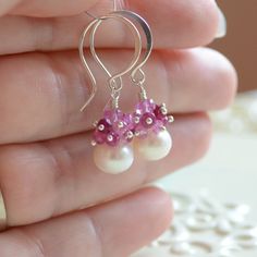 These pretty ruby earrings contain clusters of genuine ruby gemstones in shades of pink and red, perched on top of beautiful freshwater pearls. The pearls are an impressive 8mm in size and are a lovely bright white. Graceful sterling silver earwires complete the look. These earrings say Pink Teardrop Jewelry Beads For Crafting, Teardrop Pink Jewelry For Crafting, Pink Teardrop Beads For Jewelry Crafting, Sterling Silver Pearl Earrings With Gemstone, Round Sterling Silver Pearl Earrings, Pink Wedding Earrings With Birthstone, Sterling Silver Dangle Pearl Earrings With Natural Stones, Handmade Sterling Silver Pearl Earrings For Gift, Silver Pearl Earrings With Natural Stones As Gift