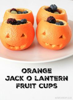 three orange jack o lantern fruit cups on a white plate with the words orange jack o lantern fruit cups