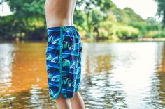 a person standing on the edge of a body of water with their feet in the water