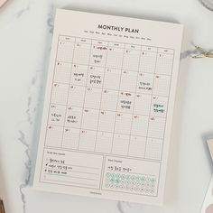 a calendar with korean writing on it next to other office supplies and stationery items