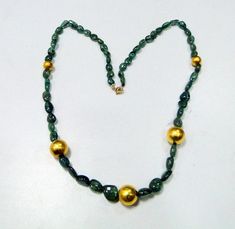 "vintage Designer 22 ct gold and high-quality natural Emerald gemstone beads necklace. Fully handcrafted vintage old 22 ct gold beads strung together with natural Oval shape emerald gemstones beads. Total Length-57 cm(22.44\")we can adjust the length, size of center gold bead-13 mm, Emerald size-12/9 mm, Emerald weight-125 carats, net gold weight approx-5 grams." Gold Emerald Necklace With Round Beads And Spiritual Style, Gold Spiritual Emerald Necklace With Round Beads, Antique Gold Polished Beads, Gold Emerald Necklace With Gemstone Beads, Antique Polished Gold Beads, Antique Large Gold Beads, Antique Gold Beaded Necklaces With Large Beads, Handmade Round Beaded Necklaces For Anniversary, Gold Emerald Necklace With Rondelle Gemstone Beads