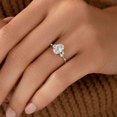 a woman's hand with a diamond ring on it