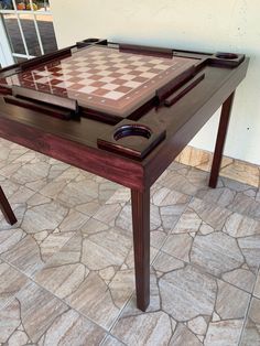 a wooden table with a chess board on it