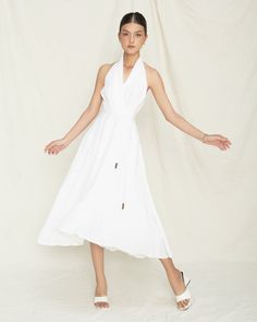 Discover the timeless charm of our Graceful White Linen Halter Dress, a must-have addition to any fashion-forward wardrobe. Handcrafted with care in Vietnam, this dress combines elegance and comfort, making it perfect for both casual and special occasions. Features: Premium Material: Made from 100% high-quality linen, offering exceptional breathability and comfort. Elegant Design: Featuring a chic halter neckline and a flowy A-line silhouette, this dress embodies modern sophistication and effort Elegant Spring Dresses For Beach Wedding, Elegant Dresses For Beach Wedding In Spring, Elegant Spring Beach Wedding Dresses, Elegant Beach Wedding Dresses For Spring, Elegant Sleeveless Midi Dress For Beach Wedding, Summer Maxi Dress For Destination Wedding, Elegant Halter Neck Maxi Dress For Beach Wedding, White Maxi Dress For Destination Wedding In Summer, White Sleeveless Dress For Destination Wedding