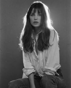 a black and white photo of a woman with long hair